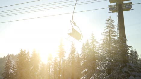 empty-ski-lift.-chairlift-silhouette-on-high-mountain-over-the-forest-at-sunset